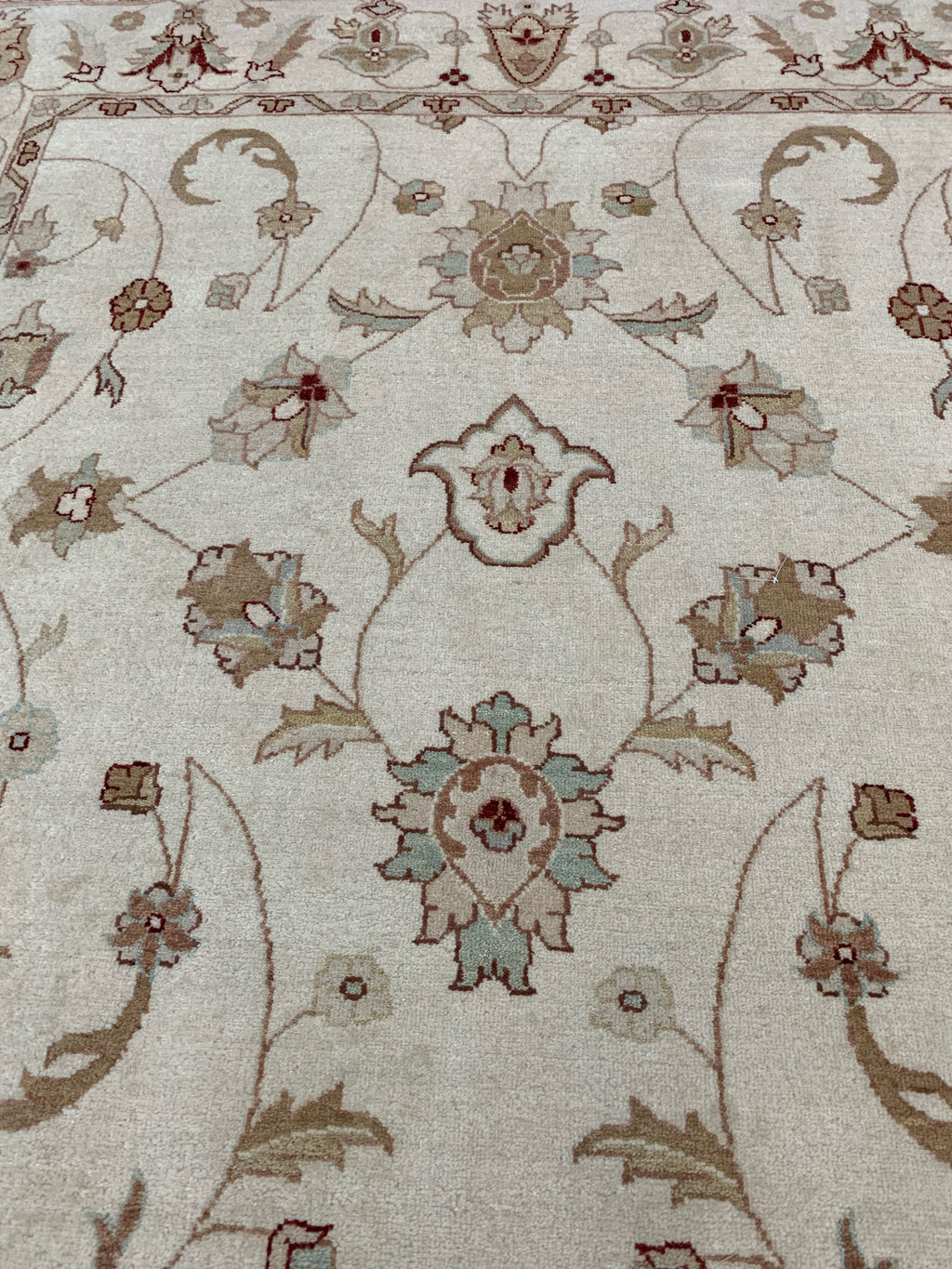 closeup of 6’7"x9’4” hand-knotted wool Oushak rug in ivory
