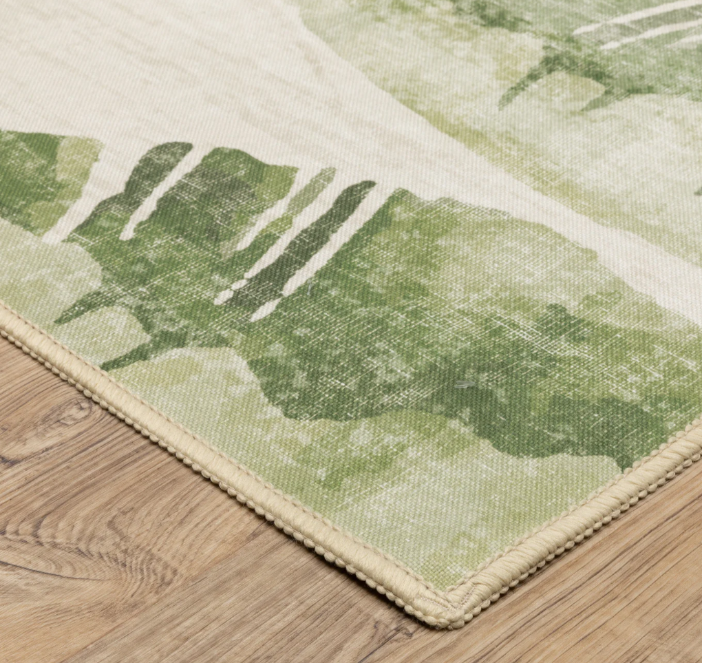 Green leaf-patterned rug on a wooden floor