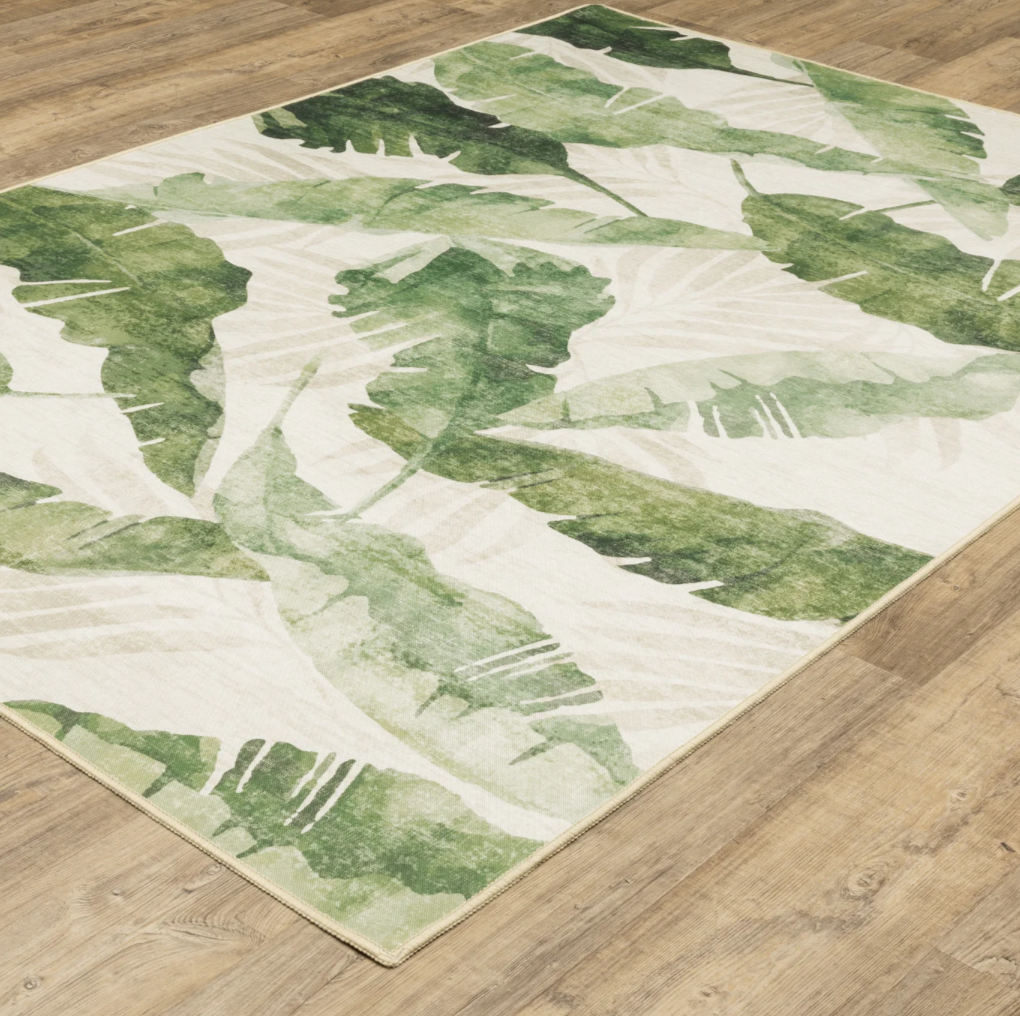 Green leaf patterned rug on a wooden floor