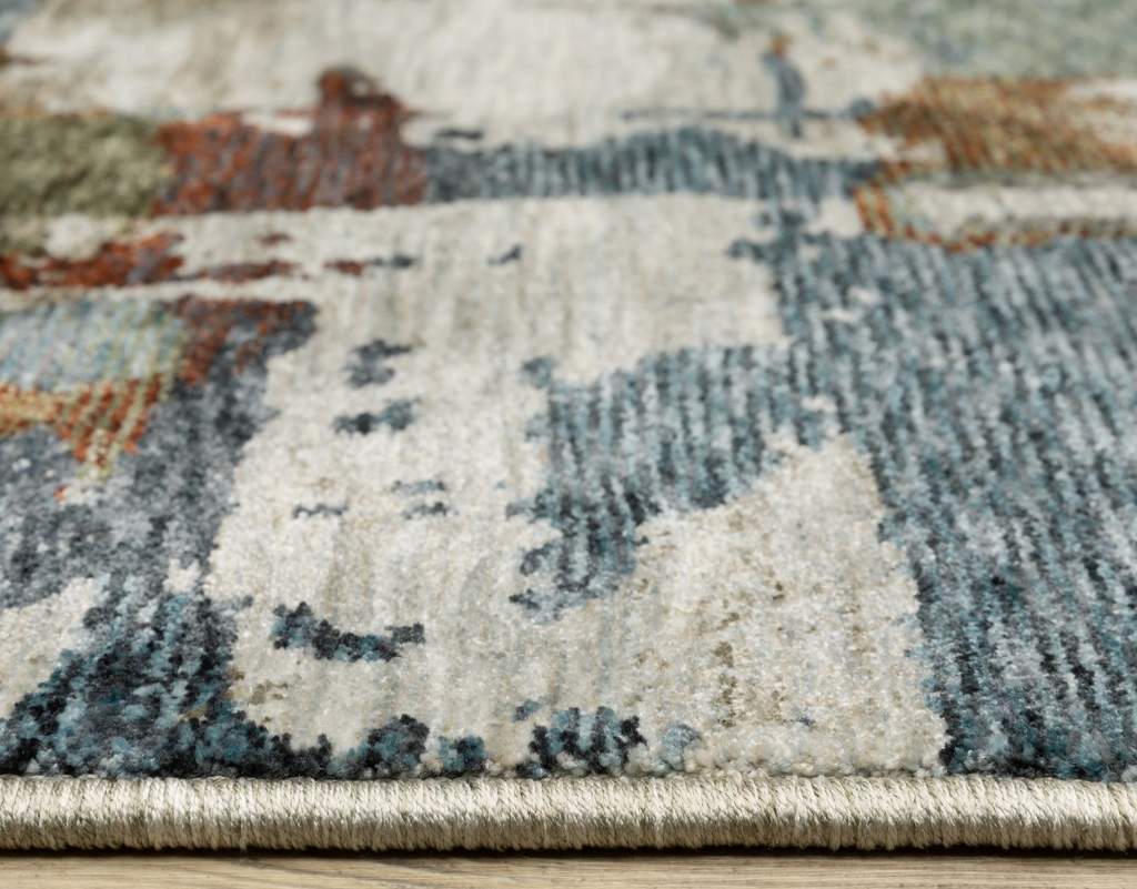 Close-up of a patterned rug with multicolor design on a wooden floor.