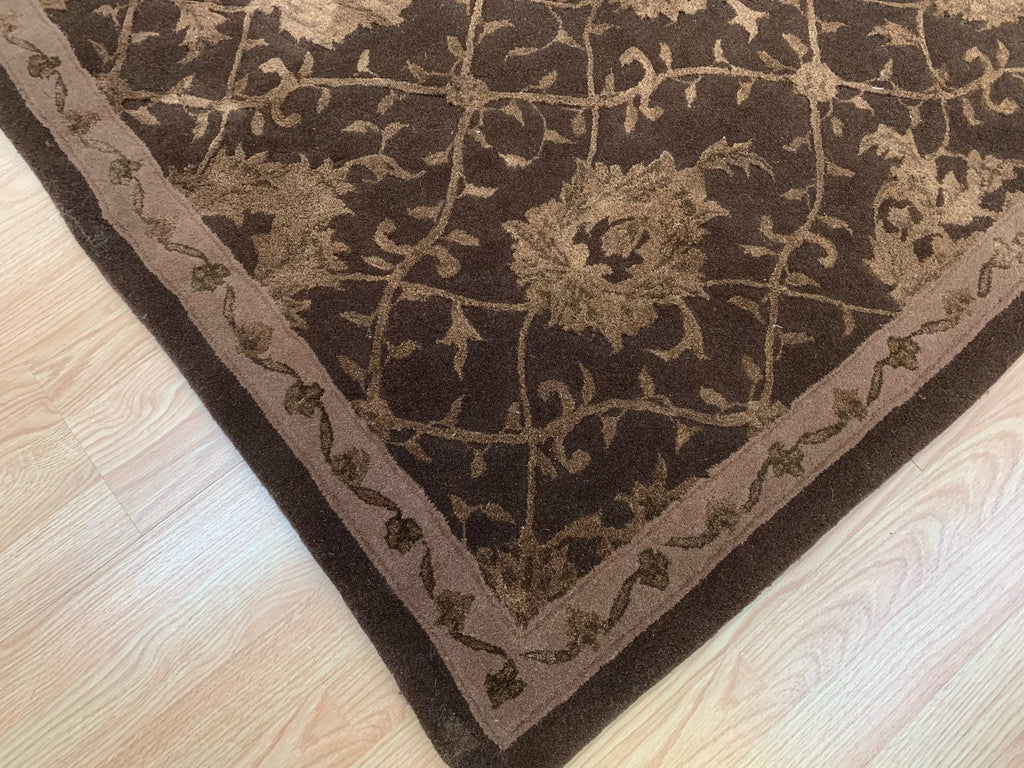 Corner of 7'9"x9'9" hand-tufted wool and silk rug with chocolate lattice pattern