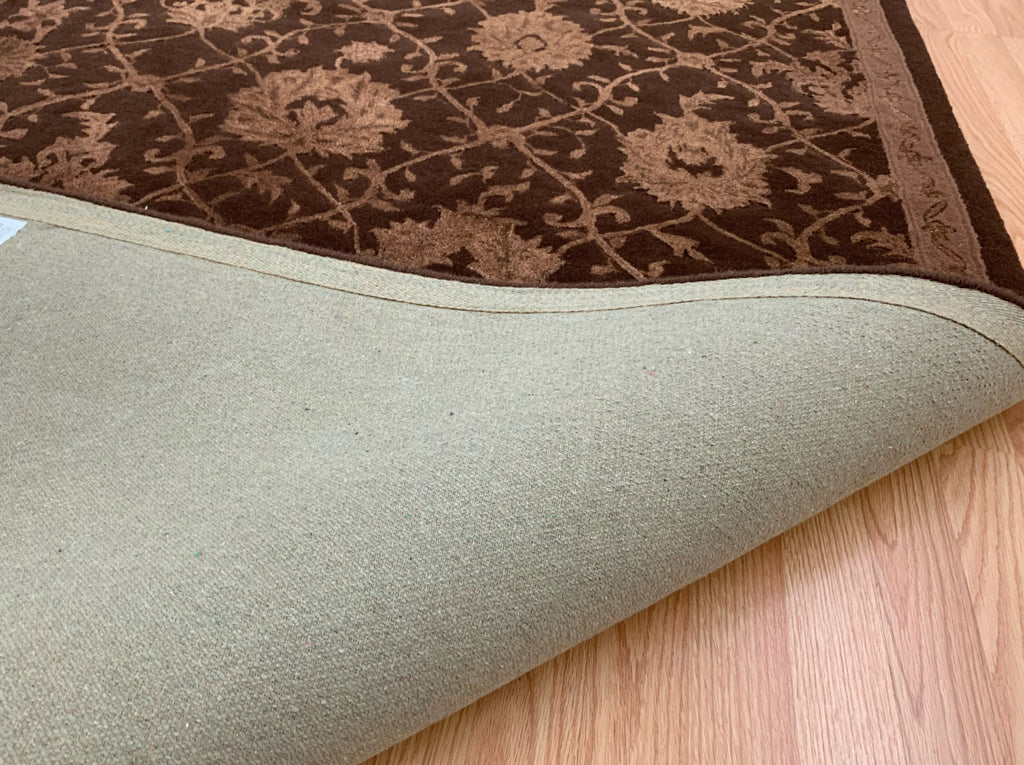 Folded back of 7'9"x9'9" hand-tufted wool and silk rug with chocolate lattice pattern